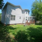 white Victorian-style house with vinyl siding